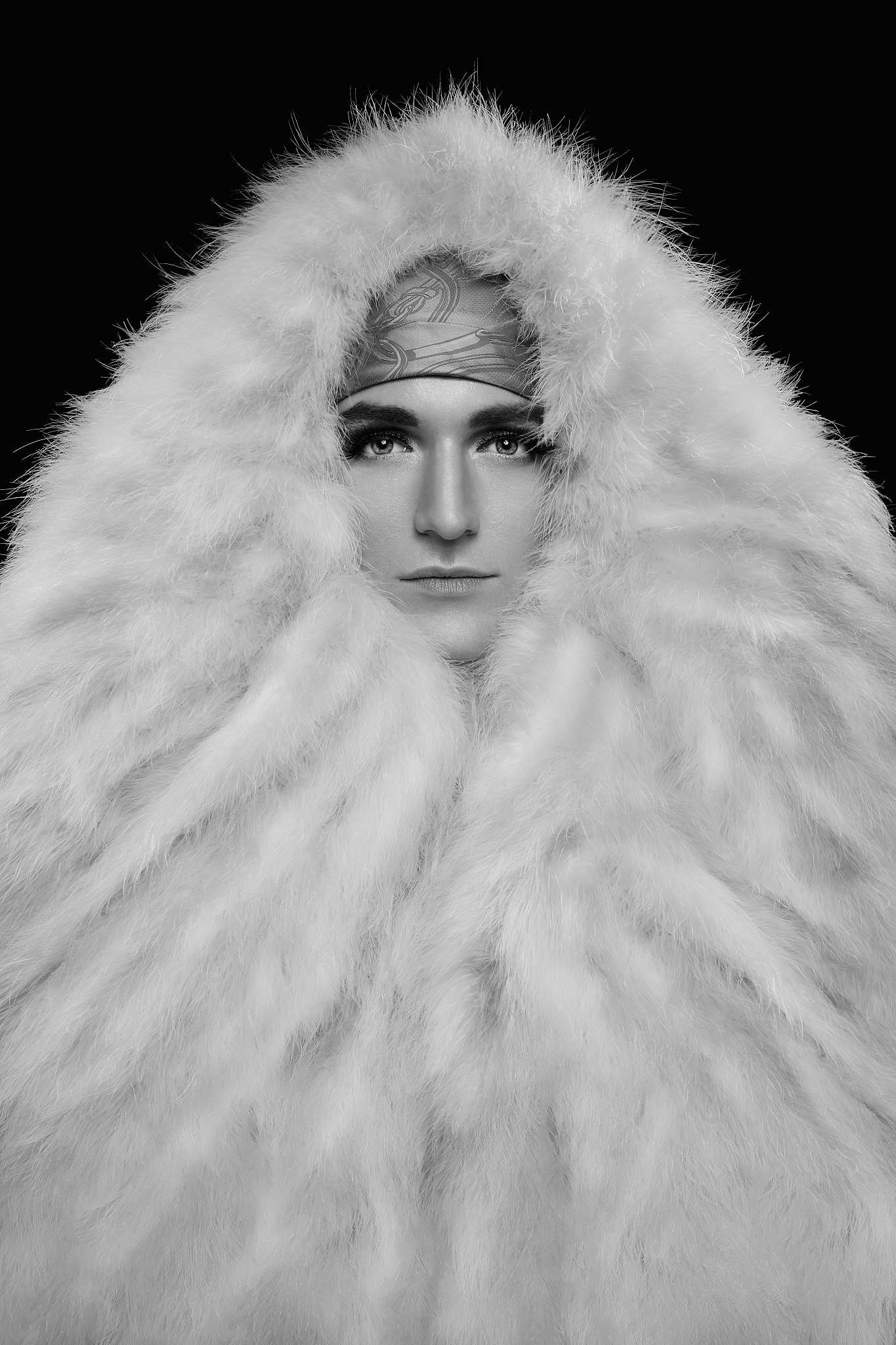 A young man wearing a huge fur-like white coat (Arnaud Gimbert).